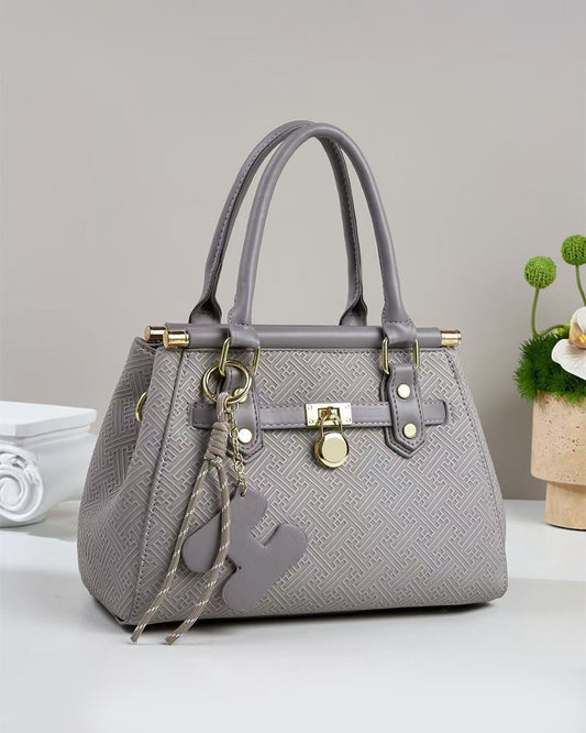 Bolso pequeño de mano con patrón geométrico grabado