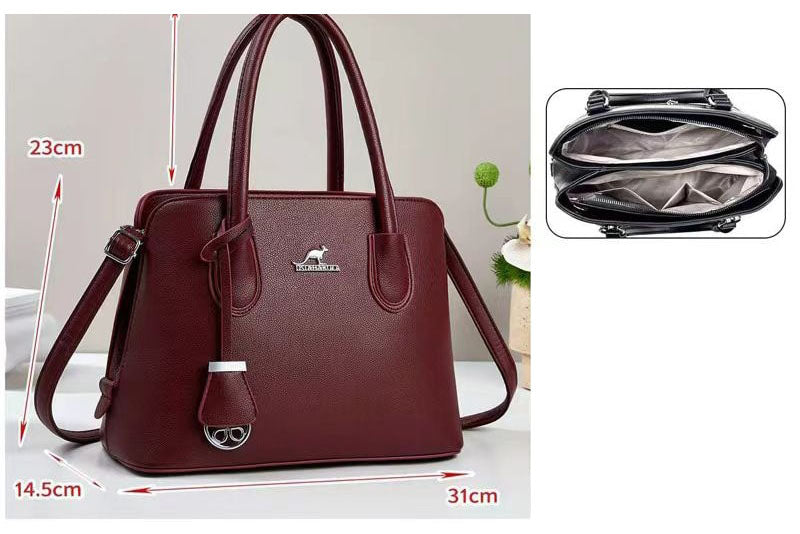 Cartera de mano con colgante decorativo en forma de anillo