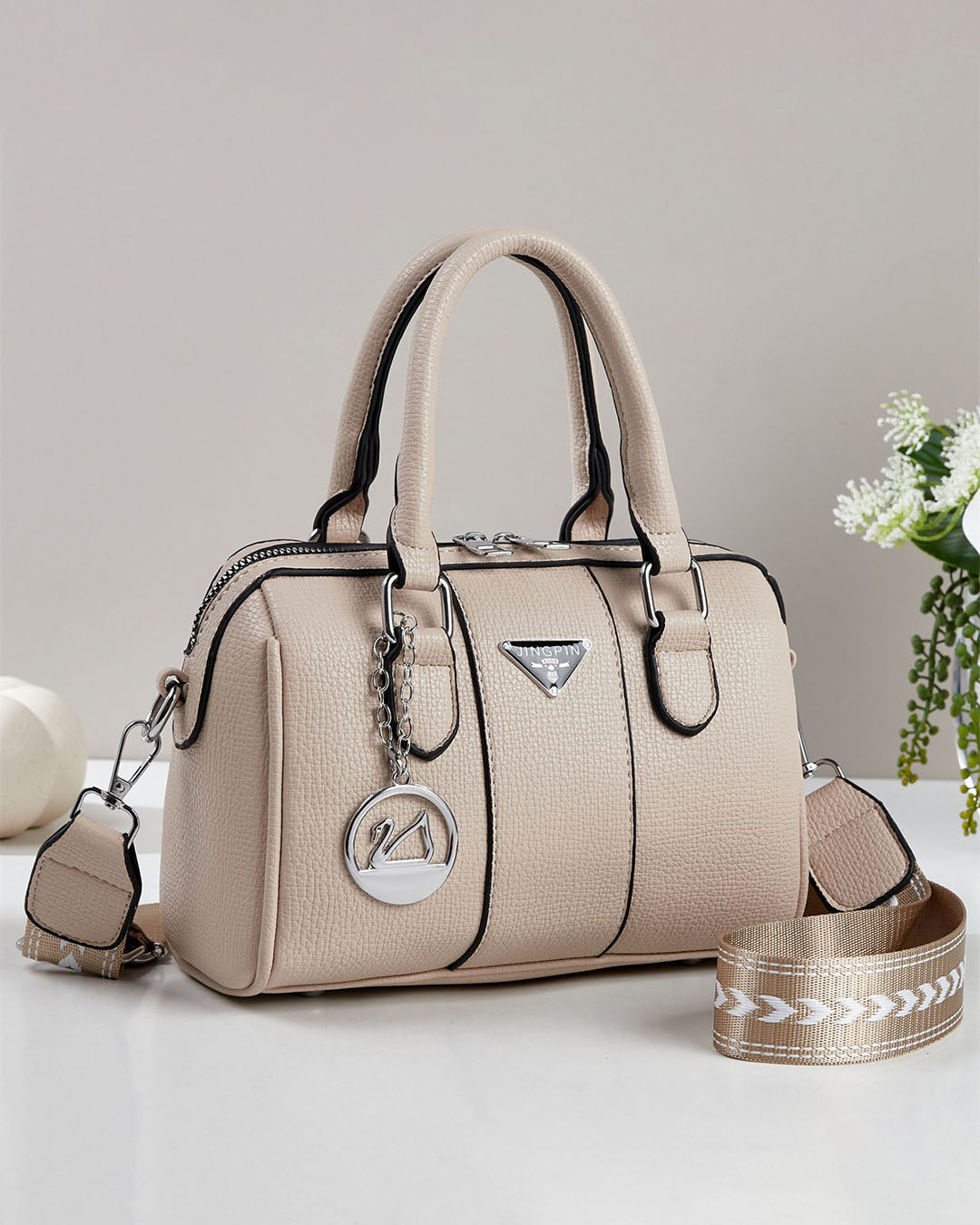 Cartera pequeña tipo baul con detalles en plateado