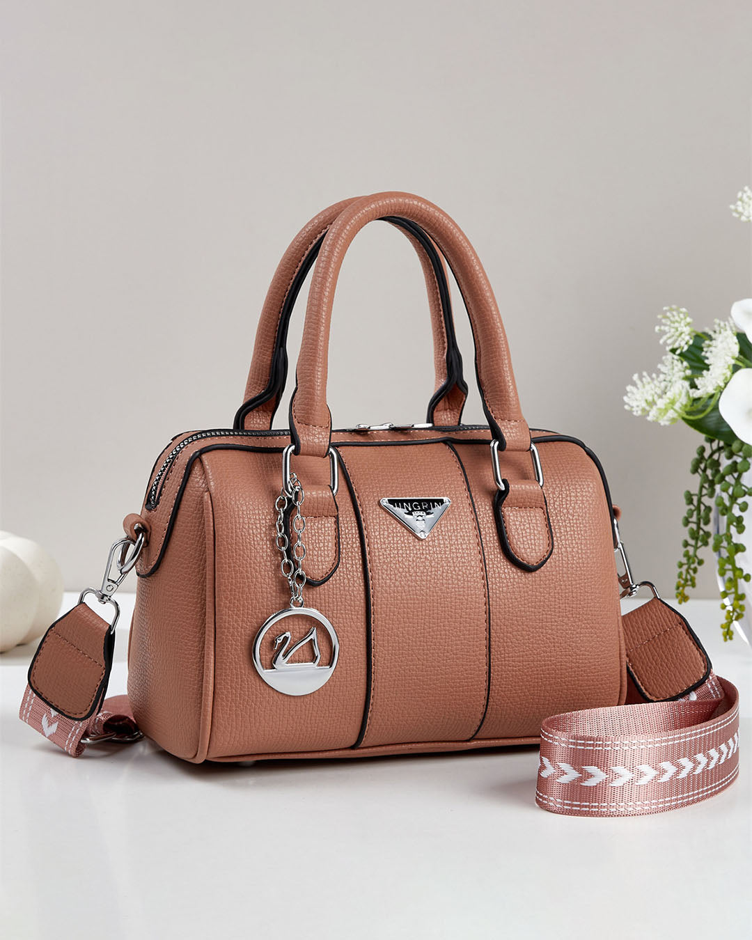 Cartera pequeña tipo baul con detalles en plateado