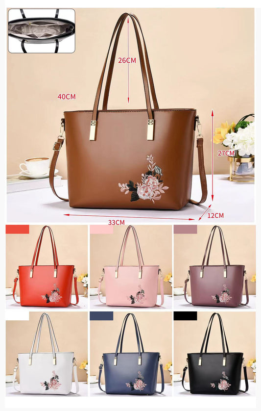 Cartera tote con detalle floral y asas largas