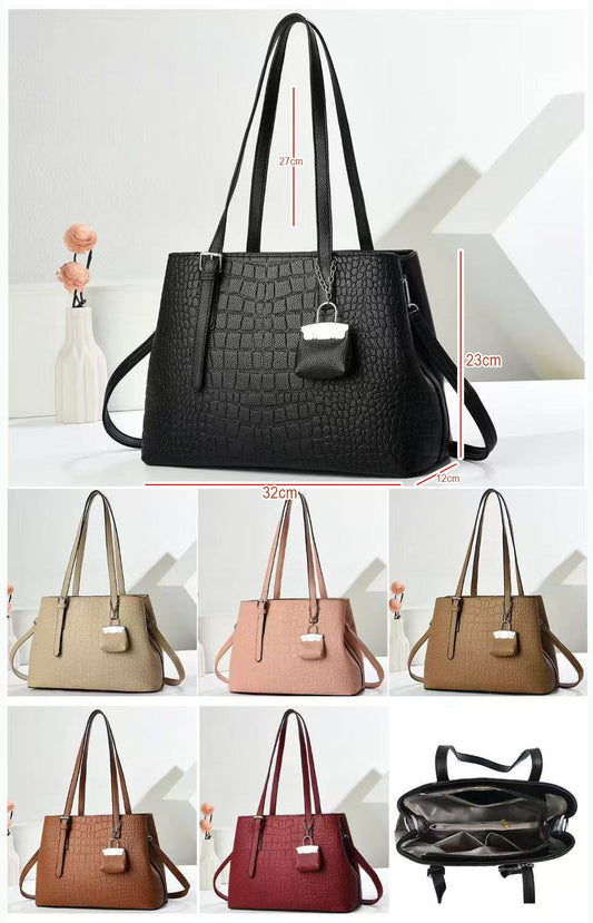 Cartera espaciosa con llavero colgante y detalles en plateado